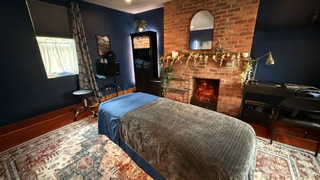 Lit fireplace and string lights in the Delmont massage room