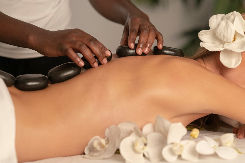 Hot stone massage therapy on a client's back