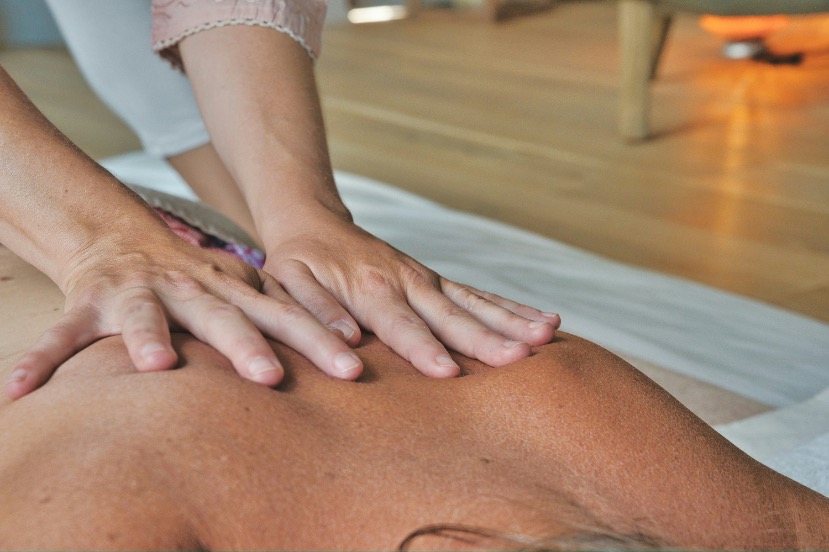 Warm bamboo massage technique on a client's back