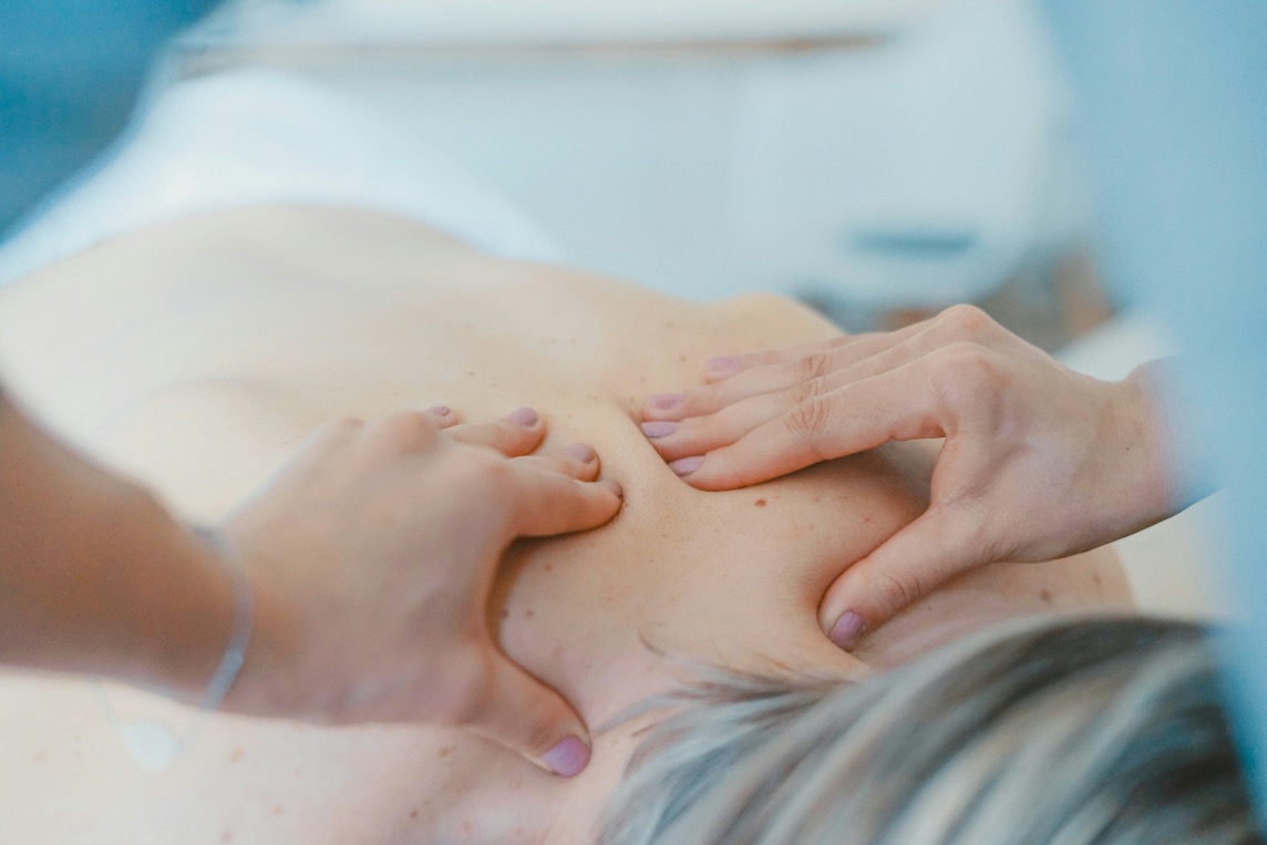 Percussion and petrissage massage technique on a client's shoulder